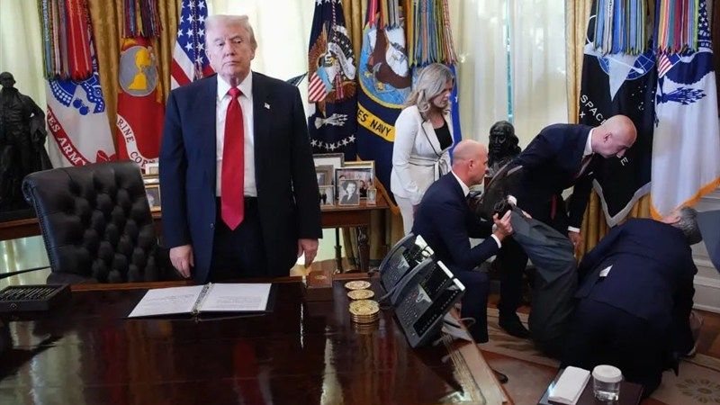 A pharmaceutical representative collapses in the oval office while Trump stands motionless.