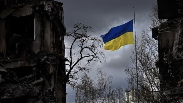 Flag of Ukraine flies of the ruins